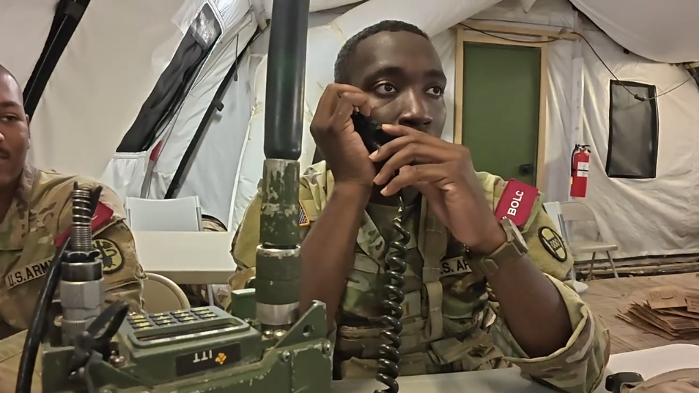 Soldier rappelling down a wall